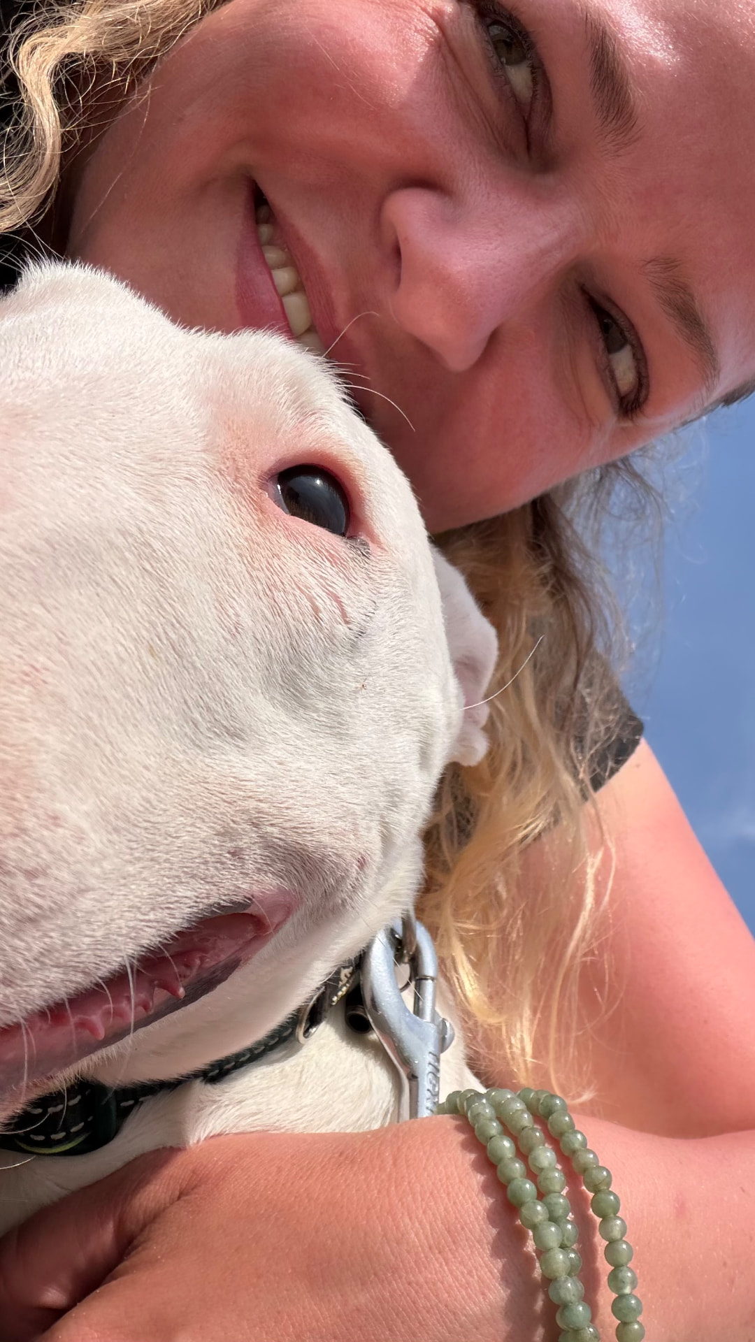 Frieda cuddling a white dog